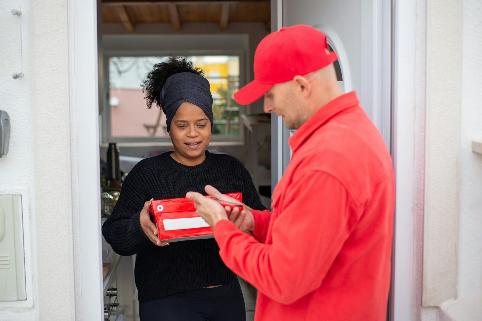 Fast & Reliable Doorstep Delivery Services Delivery agent handing a package to a customer at the doorstep, ensuring safe and quick last-mile delivery service