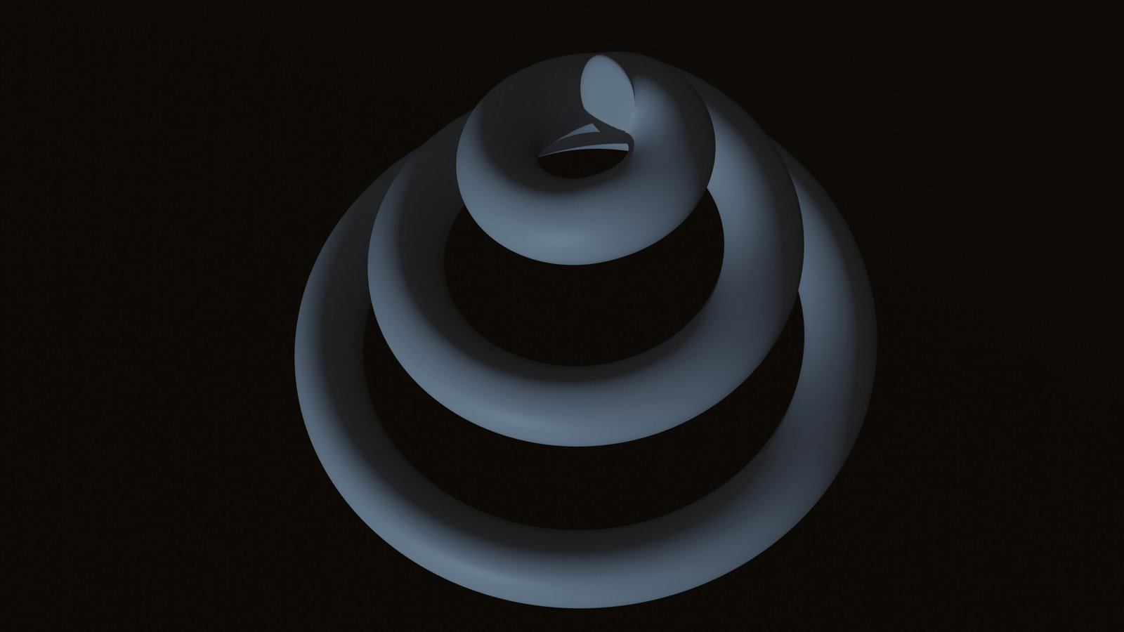 A 3D digital rendering of an abstract, dark grey spiral structure against a solid black background. The structure consists of three concentric, tubular rings that diminish in size as they wind upward toward a central, curved peak, with soft lighting highlighting its smooth, matte surface and deep shadows.